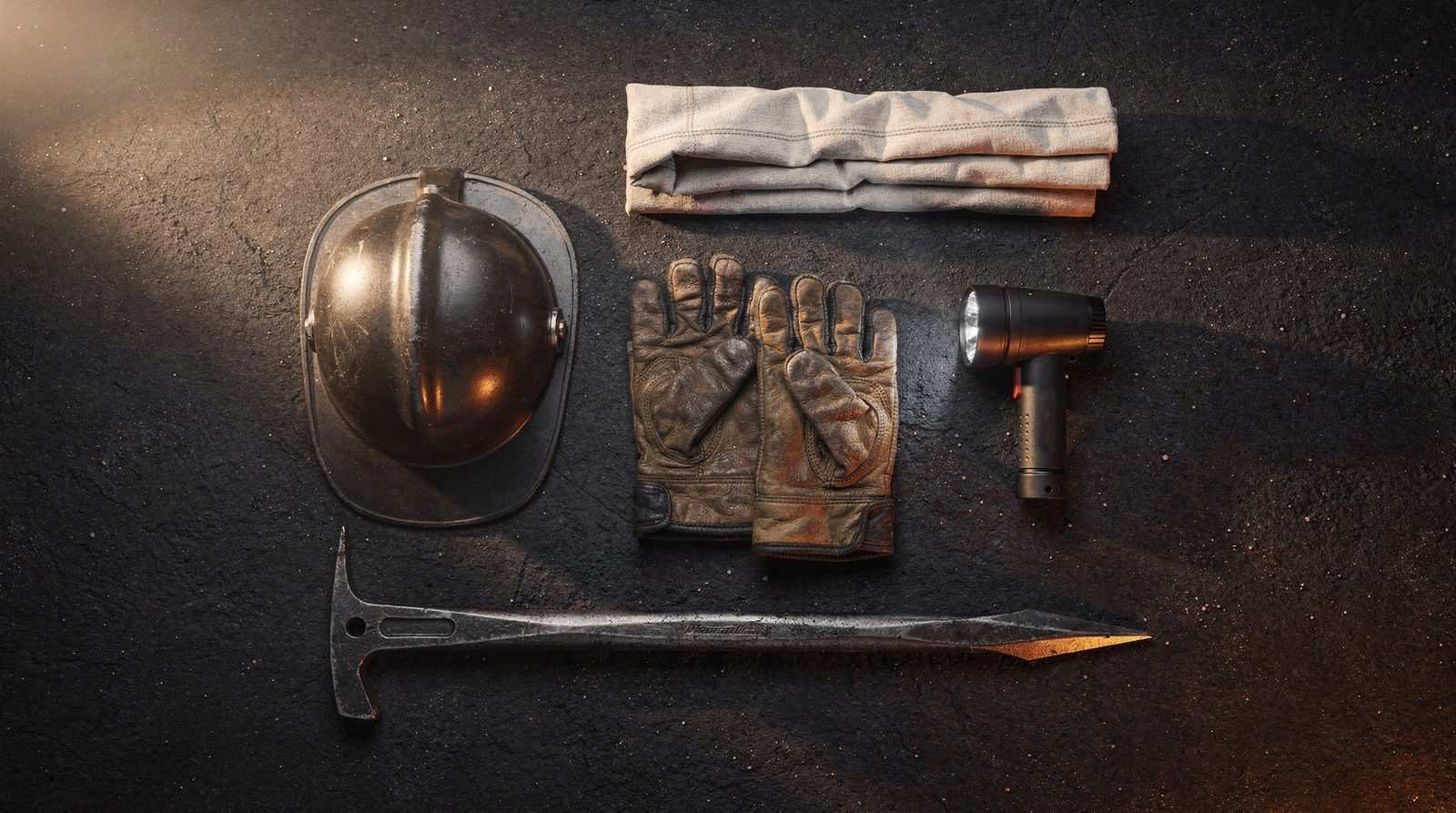 An unmarked helmet, leather gloves, a folded hood, a flashlight, and a forcible-entry bar arranged on a dark surface.